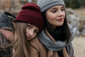 mom with adult daughter on a walk on a blurred background