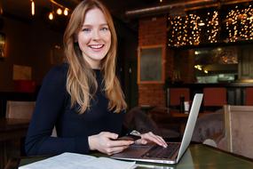 Business Lady, happy young Woman with laptop computer and smartphone