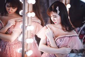 Beautiful Asian Woman posing in front of the mirror in the dressing room