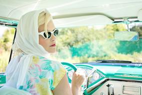Vintage photo of the colorful woman in the car