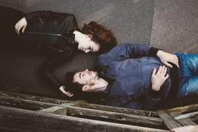young Man and Woman laying head by head