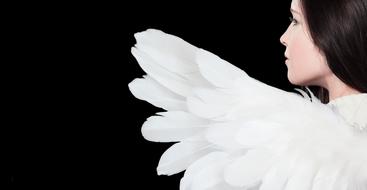 girl with white wings on a black background