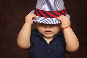 little boy wearing a hat