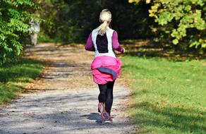 girl running along the path during fitness