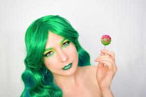 model in green with lolipops