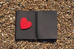 Valentineâs Day symbol, red Heart on brown notebook