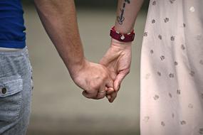 back view of adult Man and Woman Holdings Hands