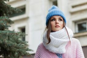 Portrait of young girl in hat and scarf outdoor
