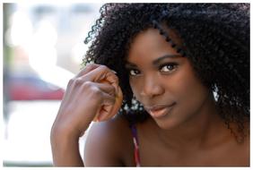 Portrait of the African American woman with black, curly hair