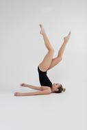 gymnastics, young girl doing shoulder stand