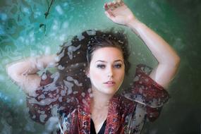 photo of a girl on the surface of soapy water