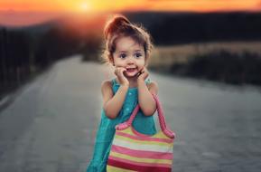 cute girl in knitted striped bag