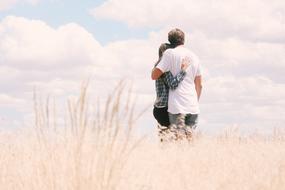 hugging young couple on the field