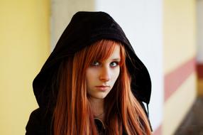 photo of a red-haired girl in a black hood