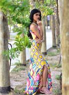 beautiful young girl stands beneath tree