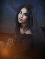 photo of a beautiful brunette against the background of the starry sky
