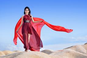 young asian Woman in Red clothe walking on sand Desert