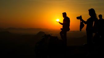 photo of man holding the sun