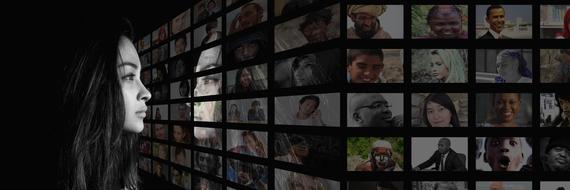 girl looks at a collage of photos