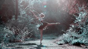 model woman in ballet pose in a forest