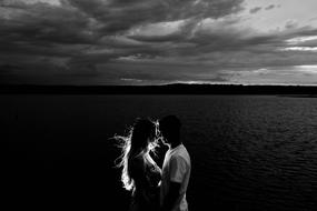 Black and white photo of the couple near the water