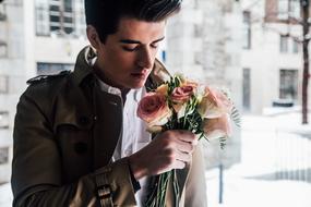 young man with a bouquet of roses