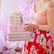 Stack Of Christmas Presents in female hands