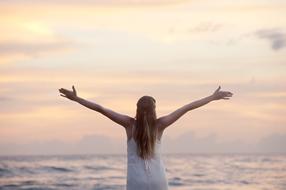 Woman standing near the water on the seascape