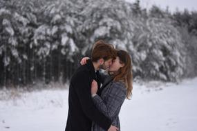 Picture of kissing Couple in a snowy forest