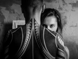 men with a large tattoo