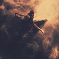 mystical image of a girl in a black dress flying through the sky