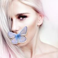 portrait of a girl with a blue butterfly on her lips