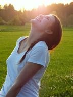 happy young Girl looking up on Meadow