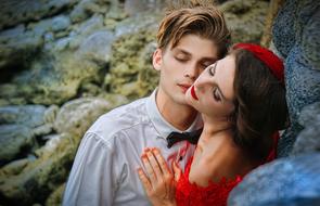 couple in love posing near large stones