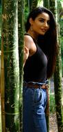 model posing near bamboo trunks