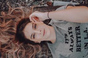 portrait of recumbent young woman with long hair