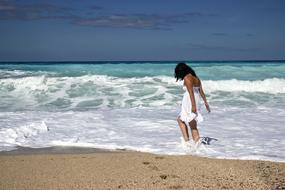 Girl walking through Sea at Beach