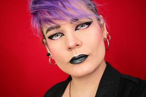 girl with purple hair and bright makeup
