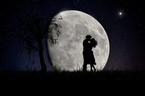 couple in love on the background of a large round moon