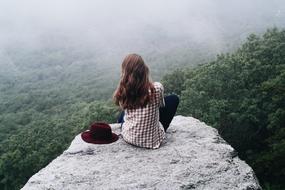 Girl on the edge on the landscape