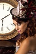 attractive girl in a hat on the background of a clock