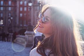 happy girl in sunglasses in the historic city center