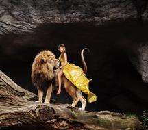 woman on a lion in the mountains as a fantasy