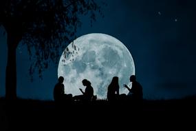 silhouettes of people on the background of the full moon