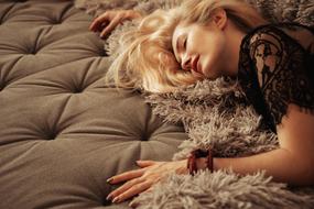 sleeping blonde on a soft stylish sofa