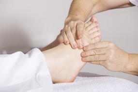 Physiotherapy, female hands doing Foot Massage