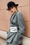 girl posing in Designer clothing at wall