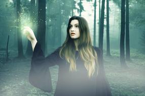 photo of a girl in a witch costume in the forest