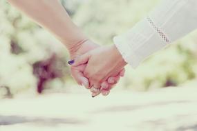 male and female hand in hand outdoor