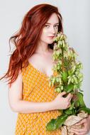 Young red haired Girl with potted plant